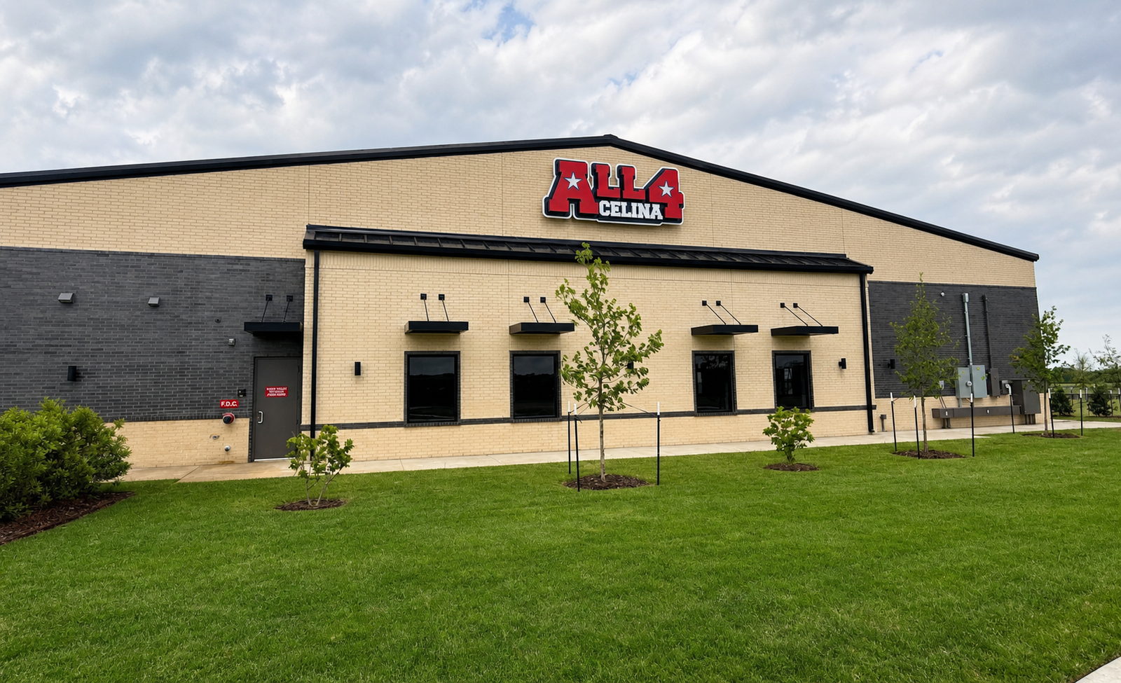 The All 4 Celina building, tan and dark grey brick with the All 4 Celina sign on the front gable.